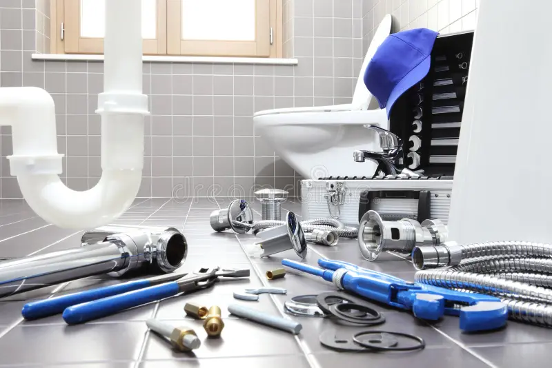 a bathroom with tools on the floor