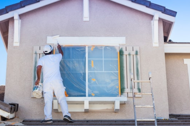 A man painting a house