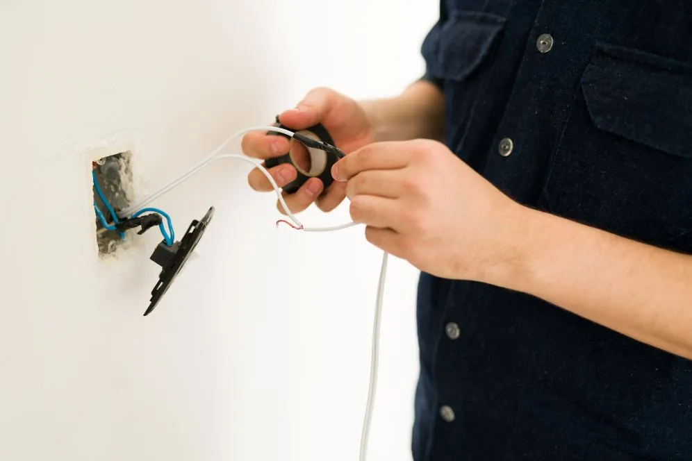 close up hands young man hands repairing broken switch doing home renovations